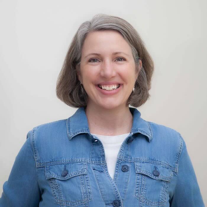 Smiling woman in a blue denim jacket