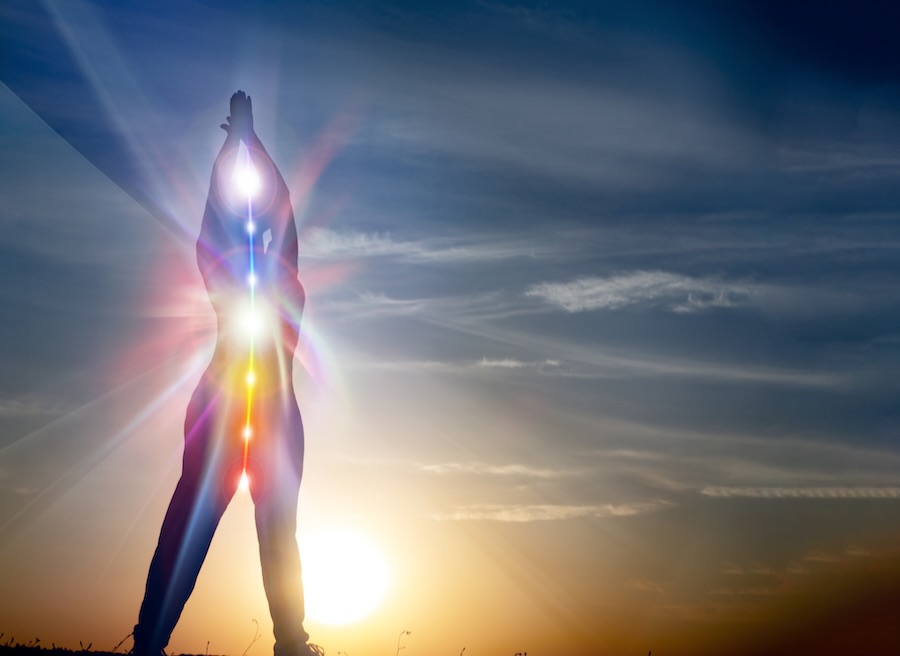 Silhouette of woman in yoga pose on beach sunset view, glowing s woman in yoga pose on beach sunset view, glowing seven all chakra. Kundalini energy. girl practicing meditation outdoors. Silhouette.